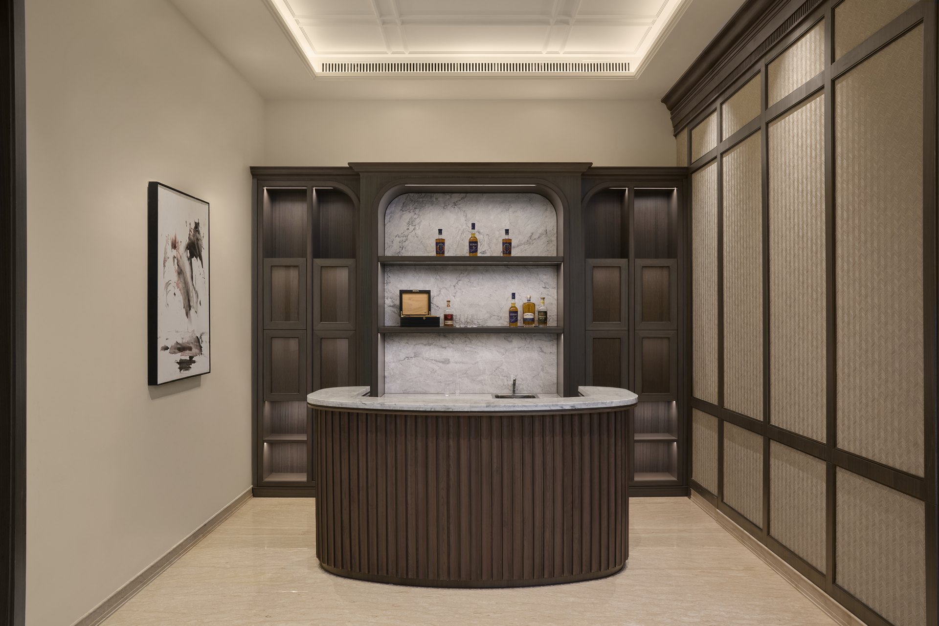 Completed bar interior with dark timber joinery and a stone counter